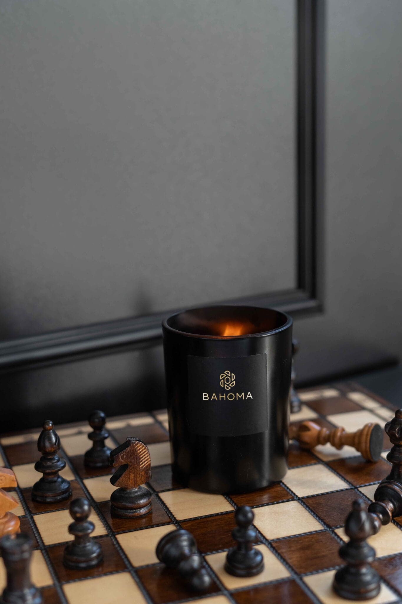 Obsidian-collection-scented-Candle-on-a-chessboard-lit-up