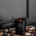 Obsidian-collection-scented-Candle-on-a-chessboard-lit-up