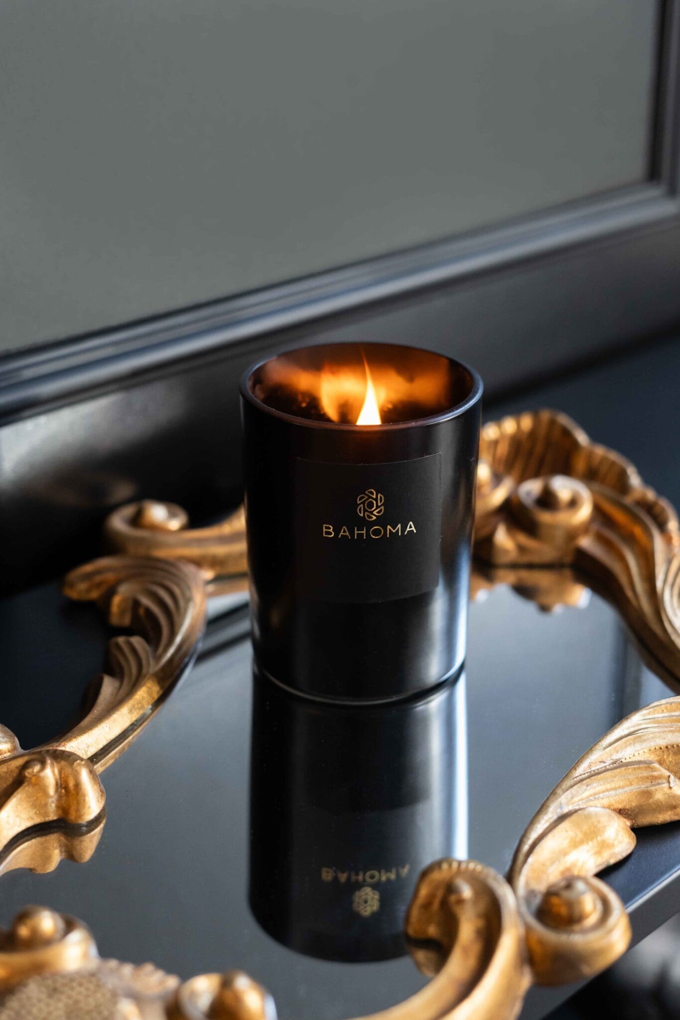 black-wax-candle-obsidian-collection-scented-Candle-on-a-mirror-lit-up