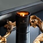 black-wax-candle-obsidian-collection-scented-Candle-on-a-mirror-lit-up