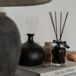 200ml-luxury-reed-fragranced-diffuser-obsidian-black-liquid-black-reeds-set-on-a-book