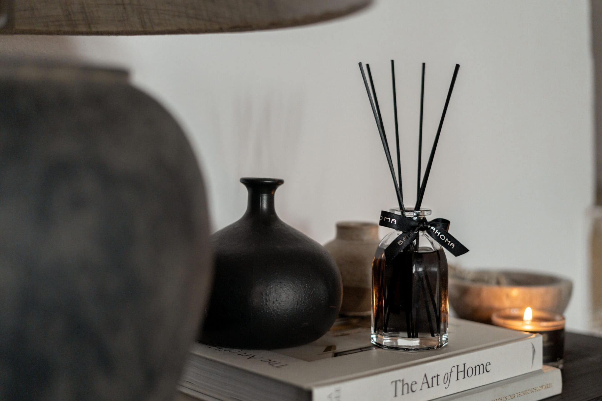 200ml-luxury-reed-fragranced-diffuser-obsidian-black-liquid-black-reeds-set-on-a-book