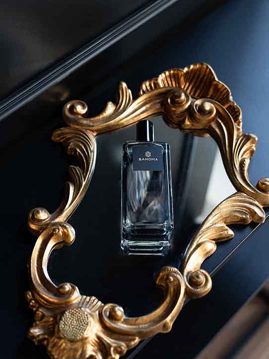 Obsidian-collection-100ml-room-spray-black-liquid-on-a-shiny-black-surface-in-a-frame
