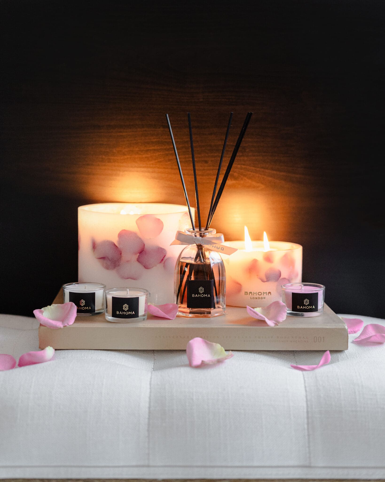 Velvet Rose - 200ml Fragranced Octagonal Diffuser with botanical candles and mini travel candles on a tray on a bed side