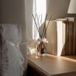 Velvet Rose -100ml Fragranced Octagonal Diffuser with a pink ribbon, on a window seal in sunshine