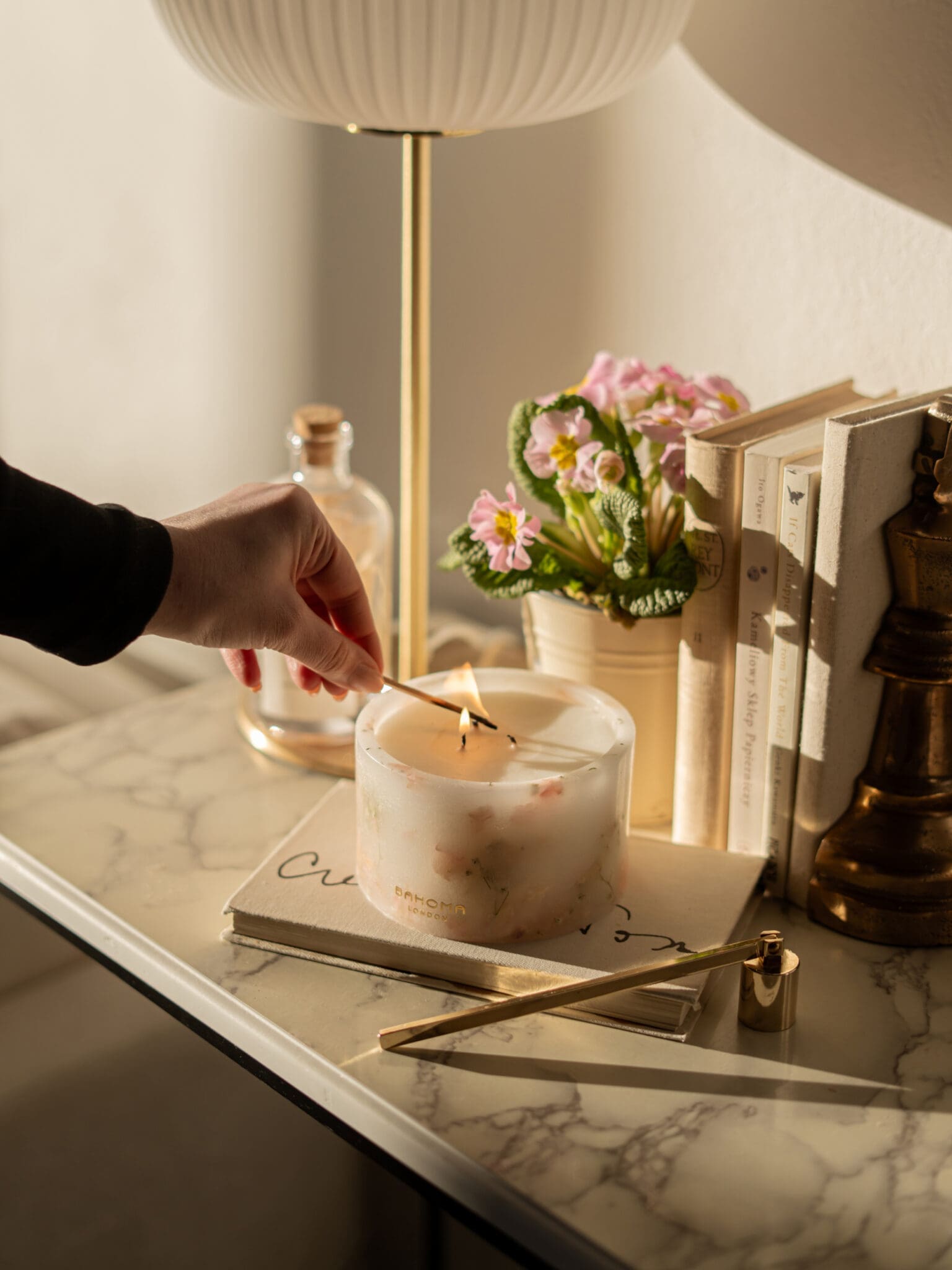 Cherry Blossom Scented Small Pillar Candle styled on a marble surface being lit.