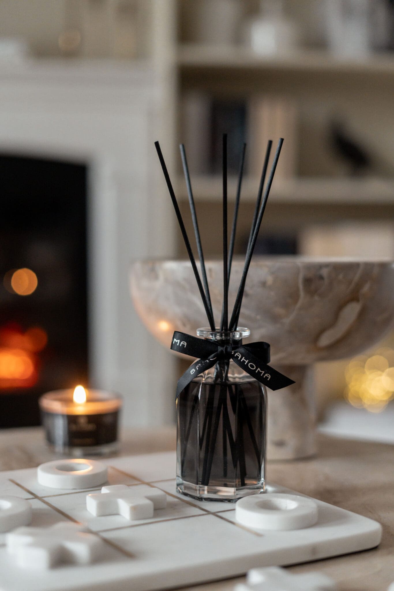 Bahoma Obsidian Collection 100ml fragranced octagonal diffuser with black liquid and black reeds styled on a table in a warm modern interior