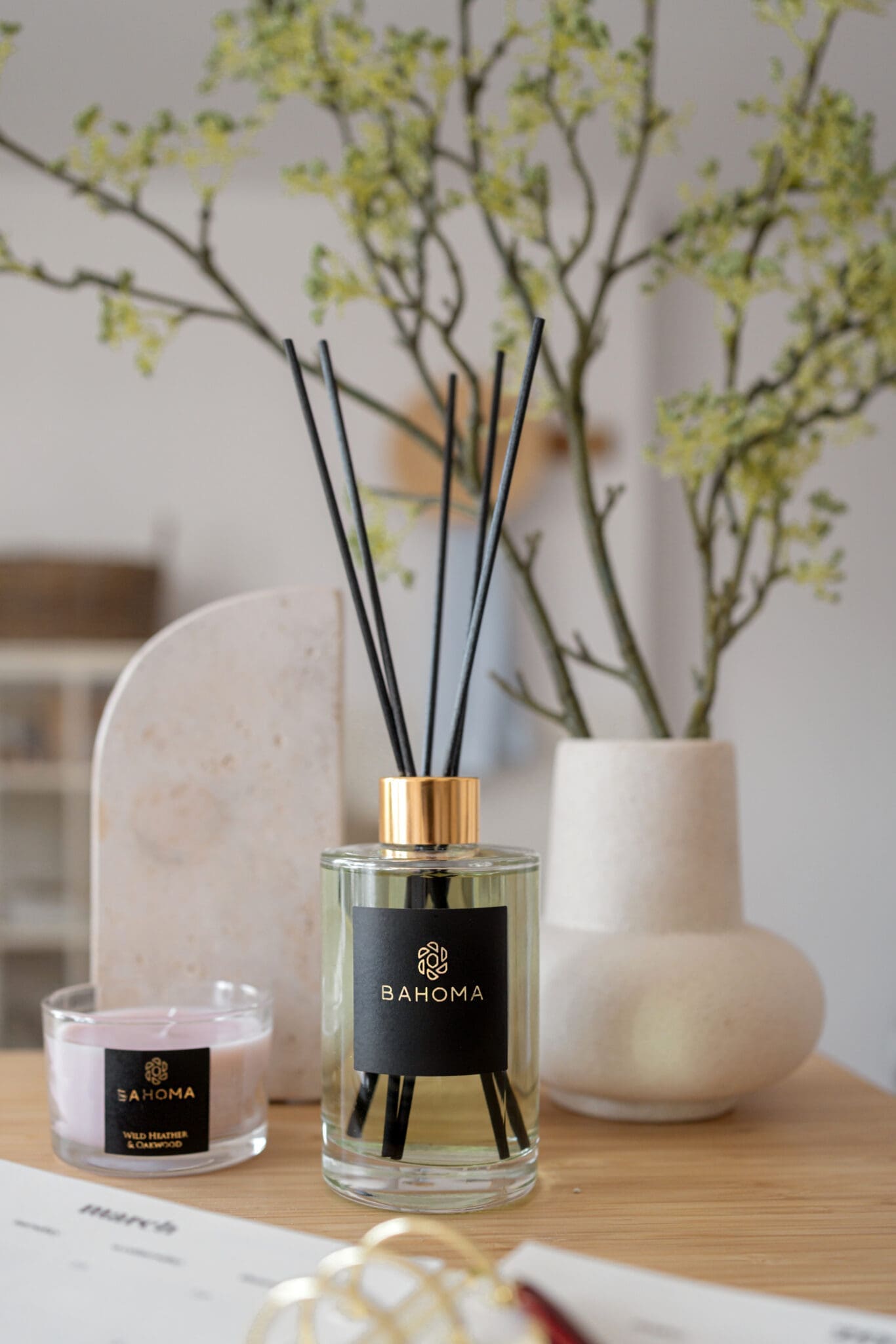 primrose-and-amberwood-200ml-diffuser-on-a-shelf-with-vase-and-candle-lifestyle-picture