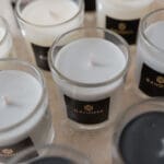 Close-up assortment of Bahoma travel candles in white, black, and taupe wax; high-quality scented candle gift set collection.